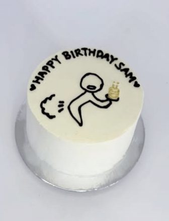 White cake with a hand-drawn Happy Birthday Sam design